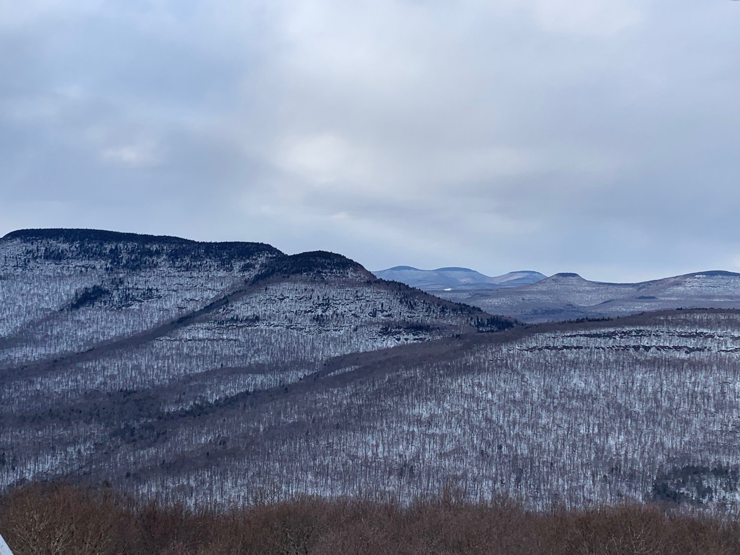 View north from the fire tower: Indian Head Mountain (left foreground); Plattekill Mountain cliffs (right foreground); Roundtop and Kaaterskill High Peak (right middle ground); and Blackhead Range (distance center).